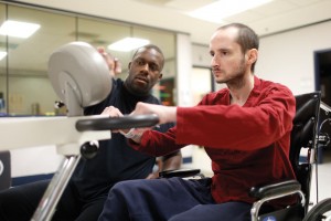 Patient James Bayne works with David Whitley to recover from injuries sustained in a car accident. Photo by John Russell.