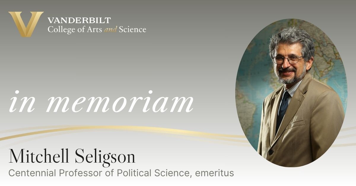 A photo of Mitchell Seligson in front of a map with the words "in memoriam" and his titale, Centennial Professor of Political Science.