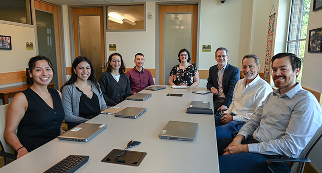 group of smiling people at a table