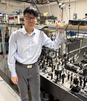 Yueming Yan standing in a lab.